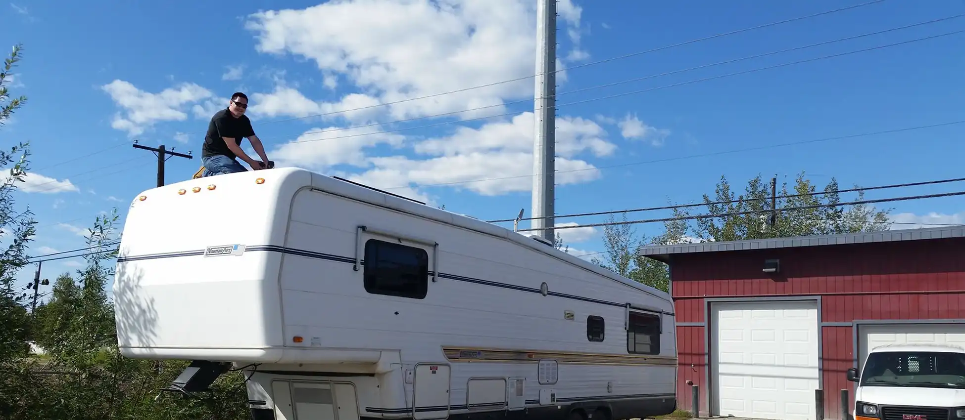 RES employee installing remote solar panels on RV
