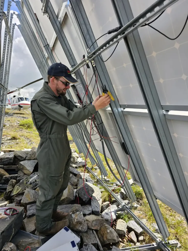 RES employee wires back of solar panel